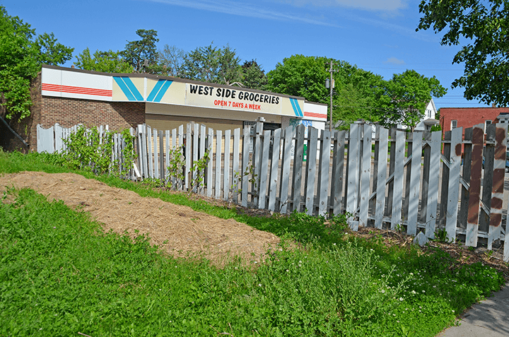 wooden fence in front of small grocery