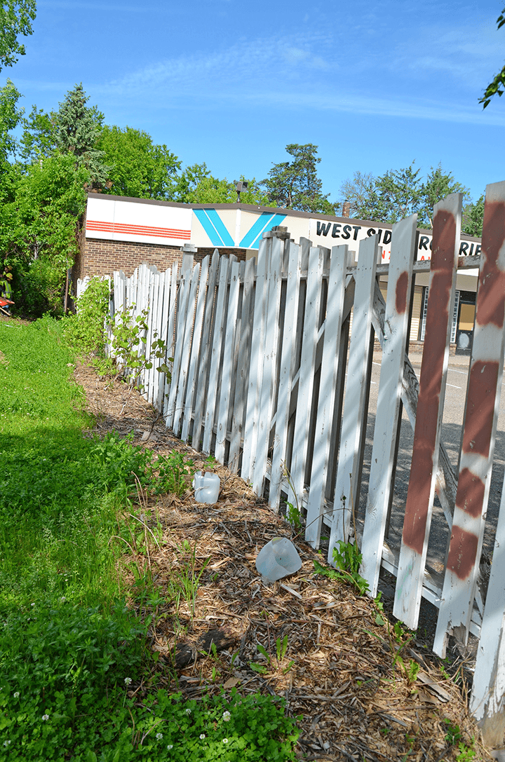 wooden fence in front of small grocery