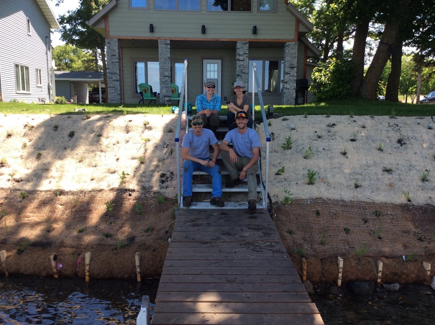 Group sitting on front steps of house