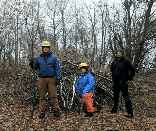 Standing in front of brush pile