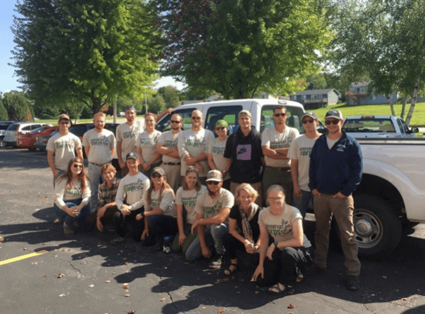 Group standing in front of truck