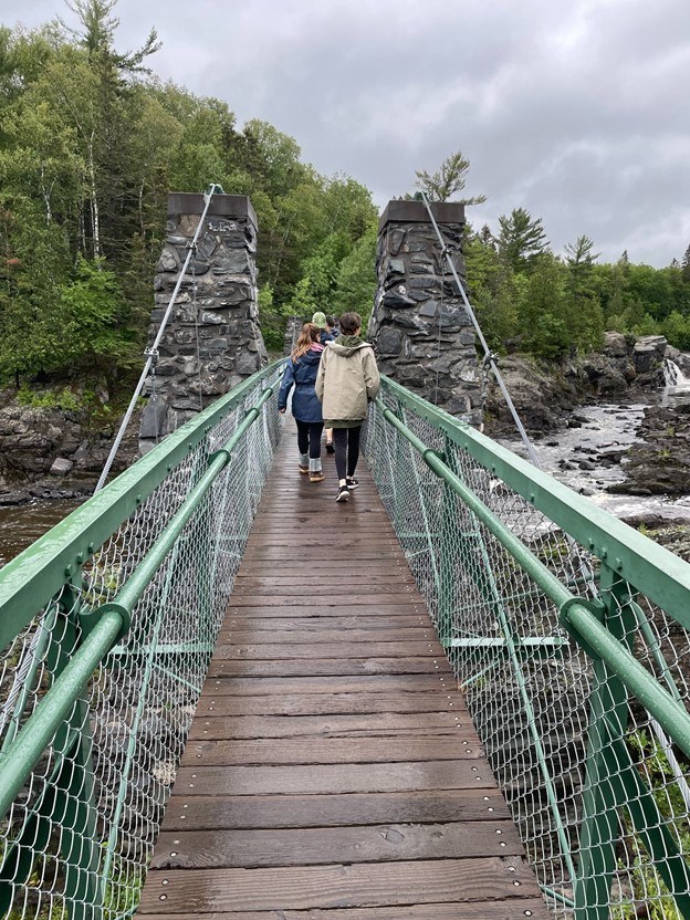 walking across bridge