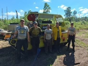 crew in front of heavy vehicle