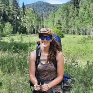 woman smiling on hiking trail