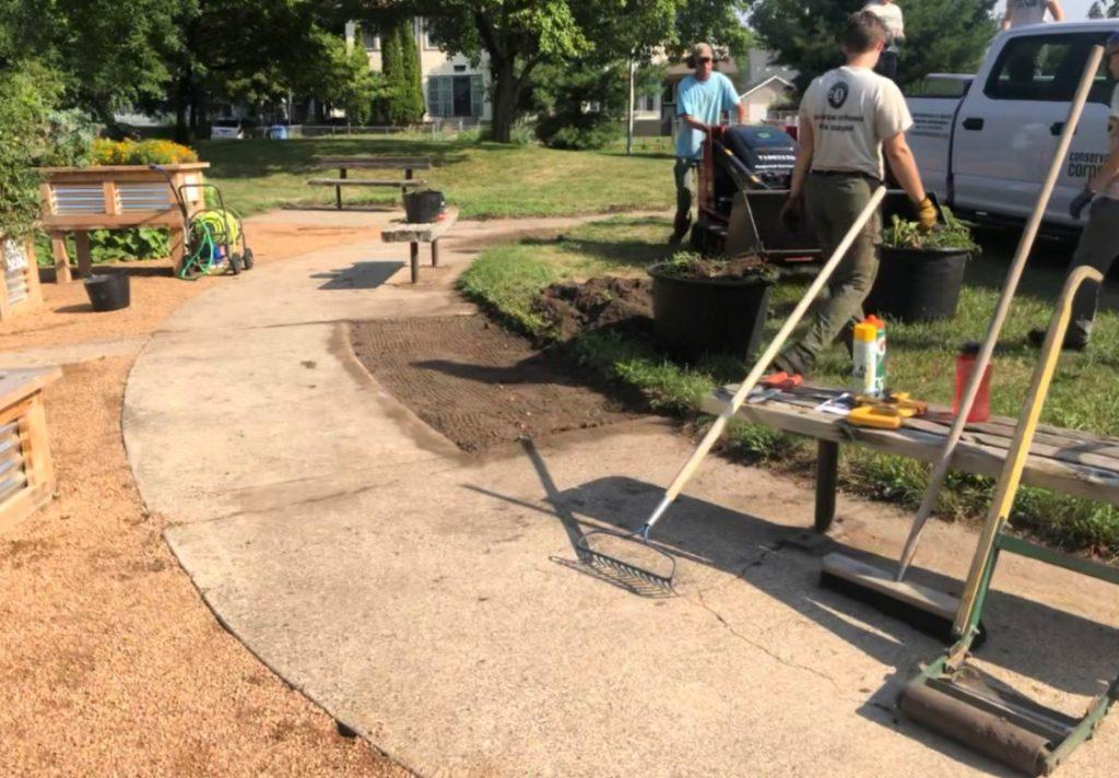 members making a new path in a garden