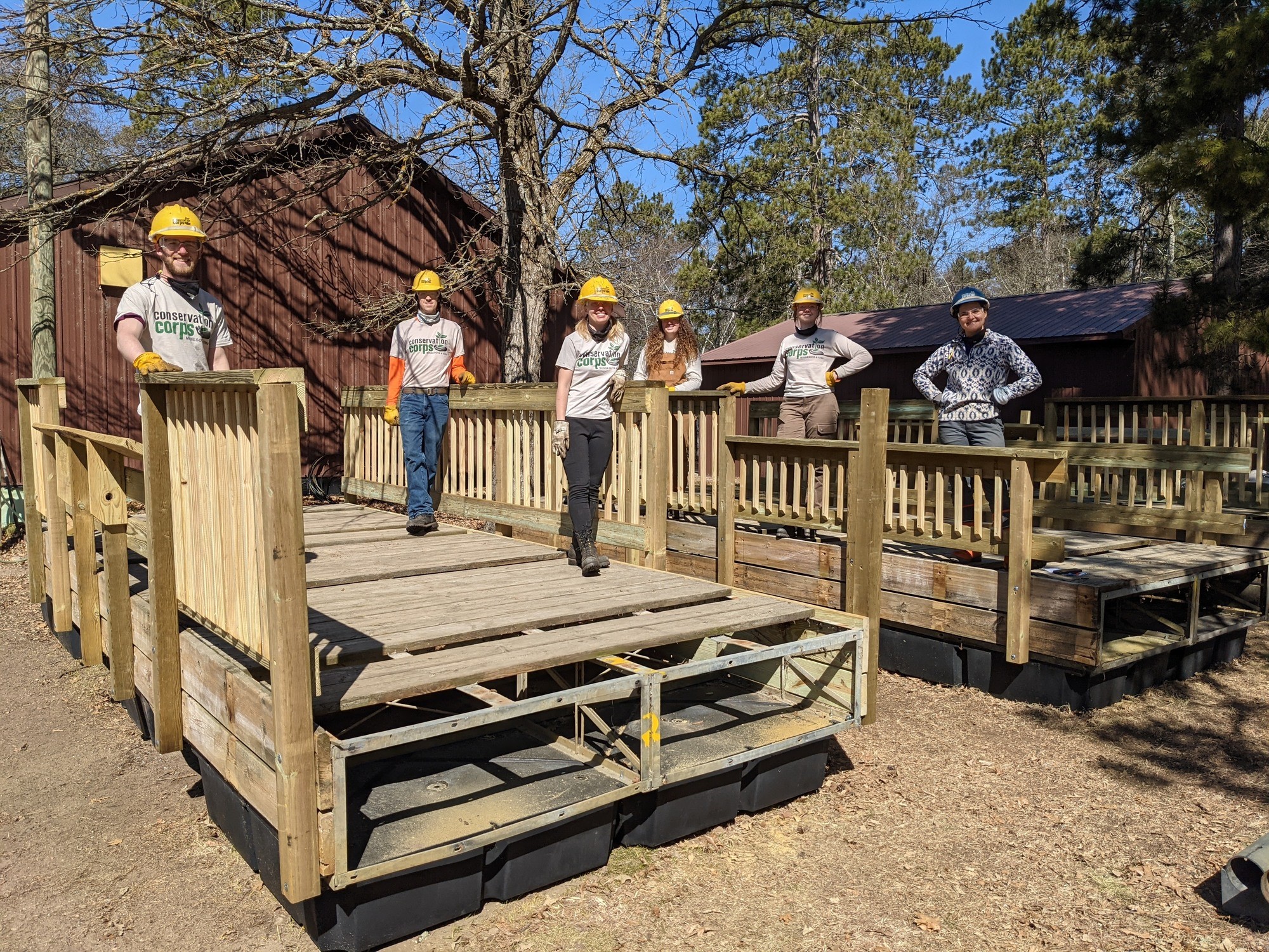 group standing on wood deck