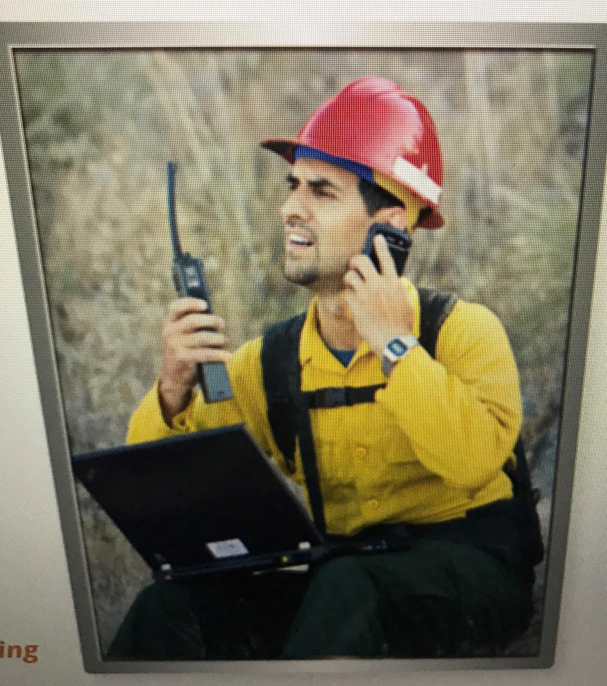 man on handheld radio looking confused