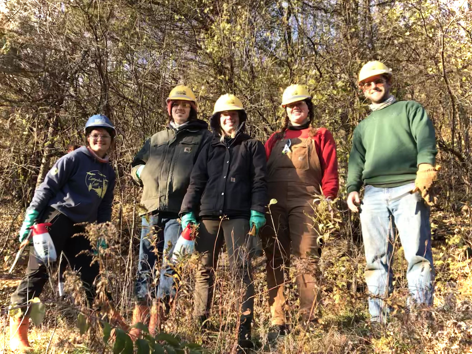 group standing in forest smiling