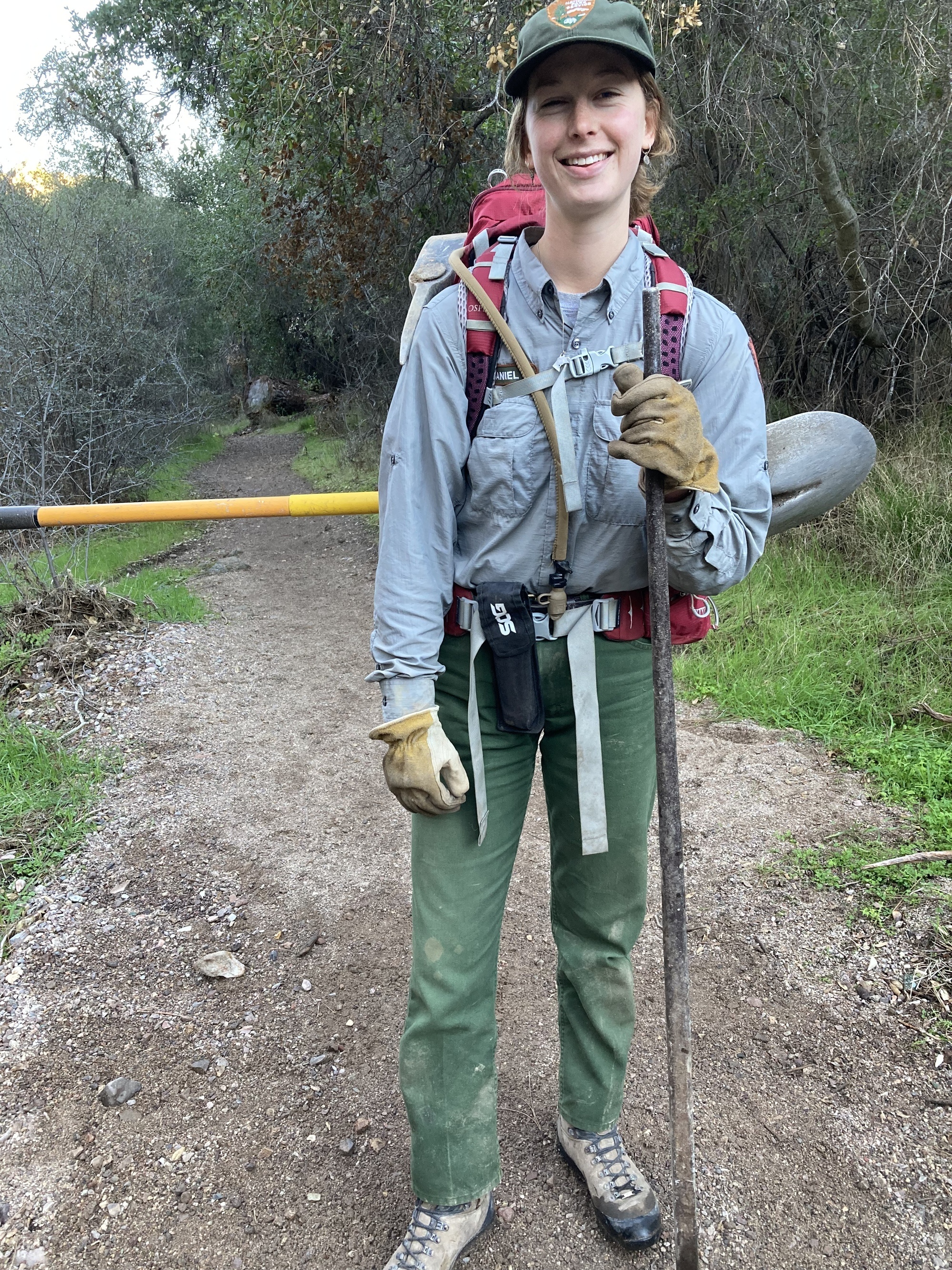 standing on the trail with tools