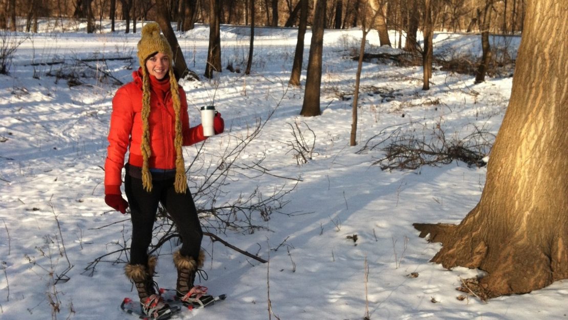 Woman standing in snowshoes in forest