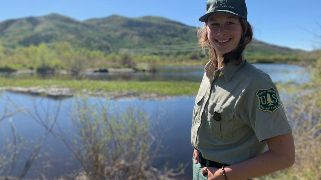 Park ranger smiling by lake