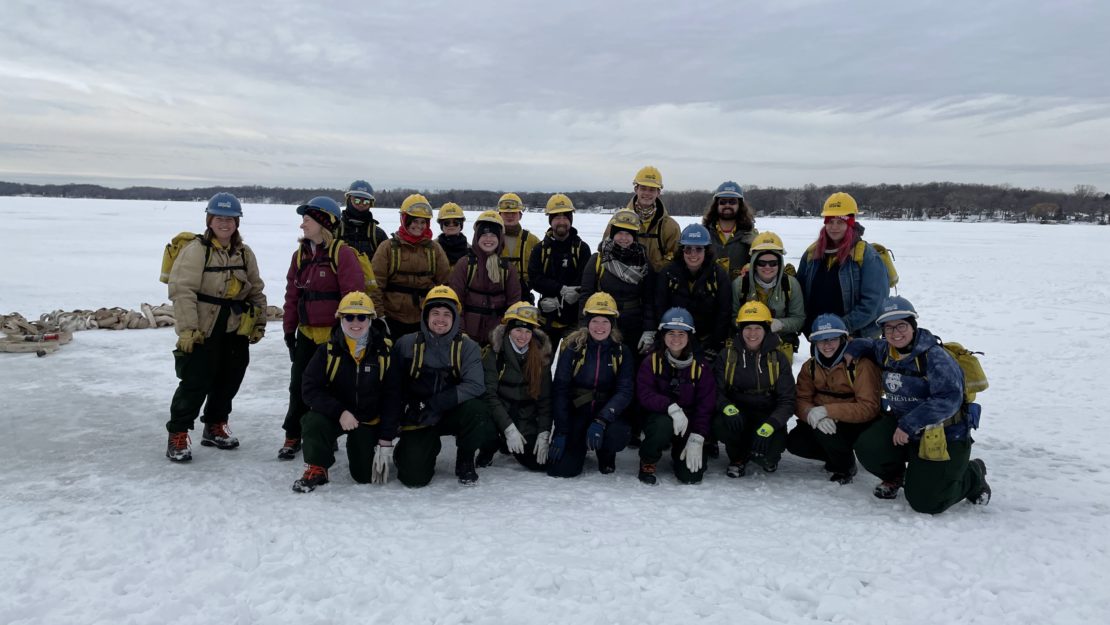 Group photo in fire gear on snowy field