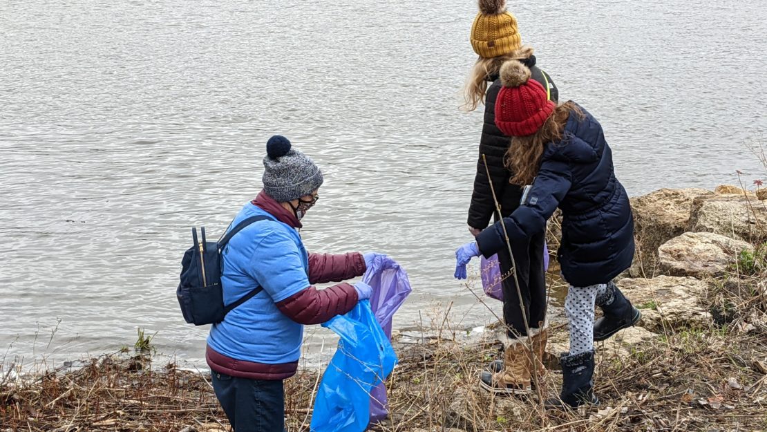 picking up trash by the Mississippi River