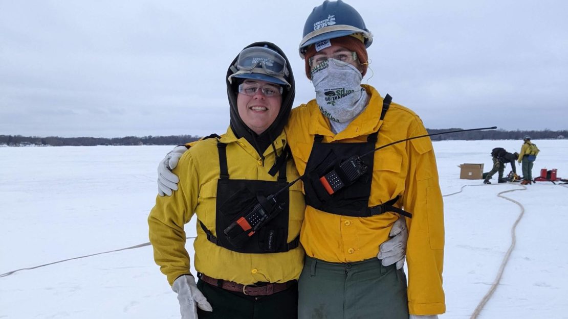 two members in fire gear on frozen lake