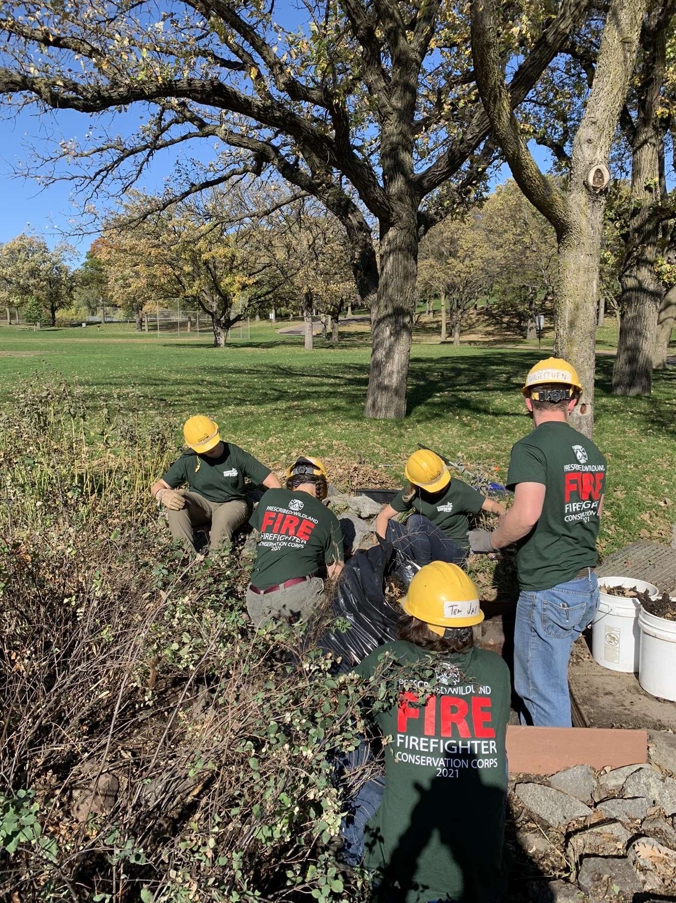 people wearing fire shirts sitting in group