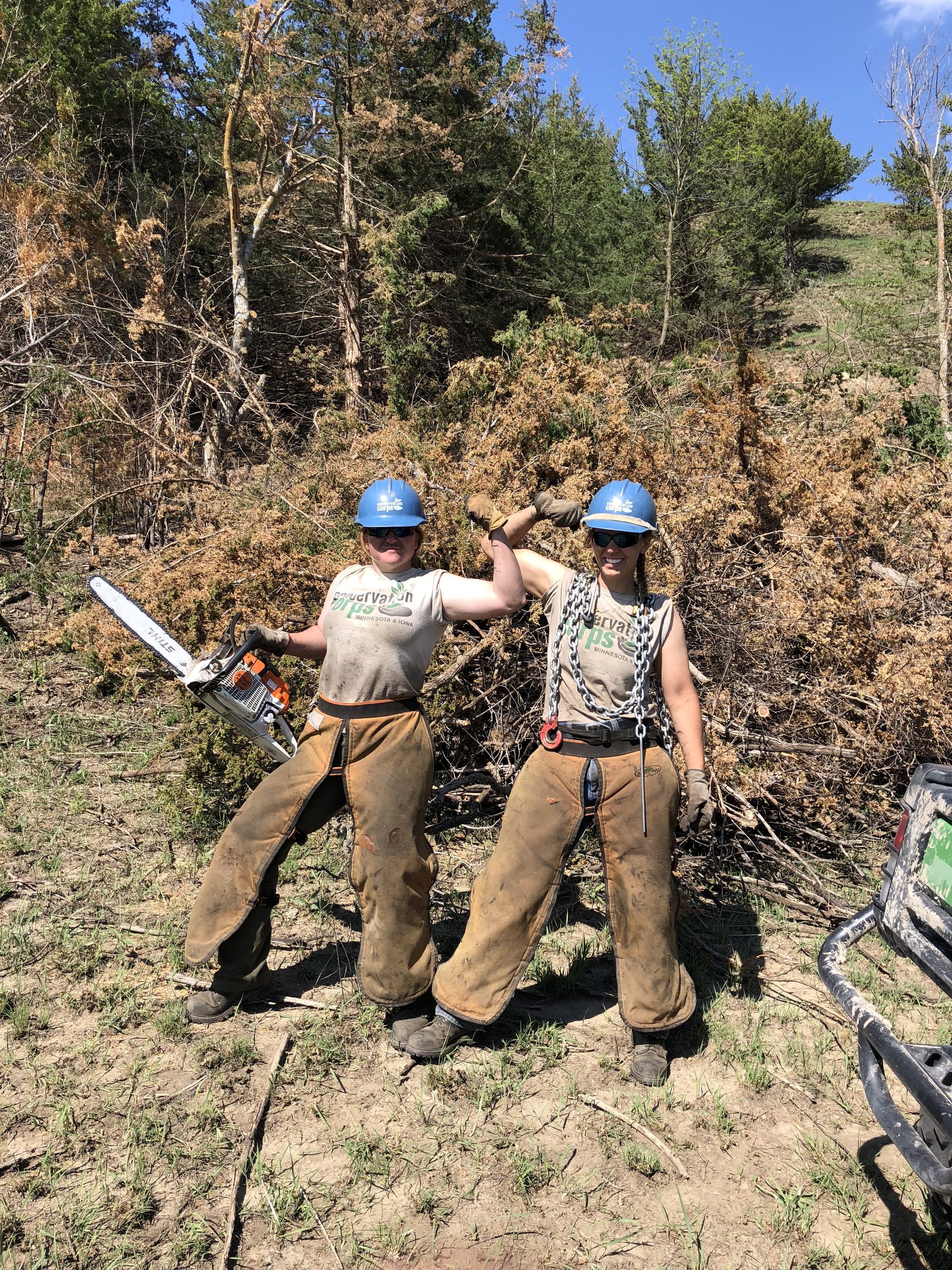 flexing muscles holding chainsaws