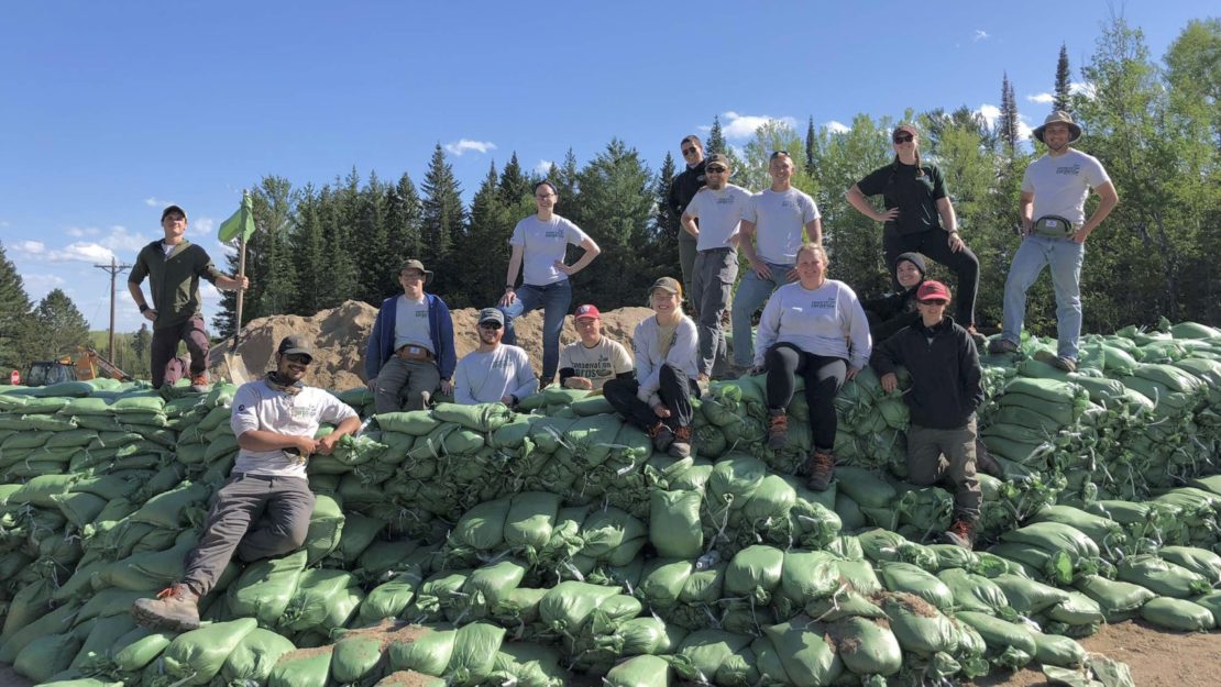 group standing on sandbags