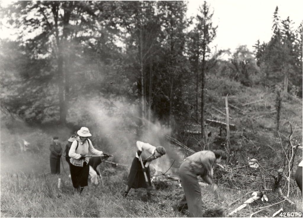 old black and white photo of women fighting wildfire