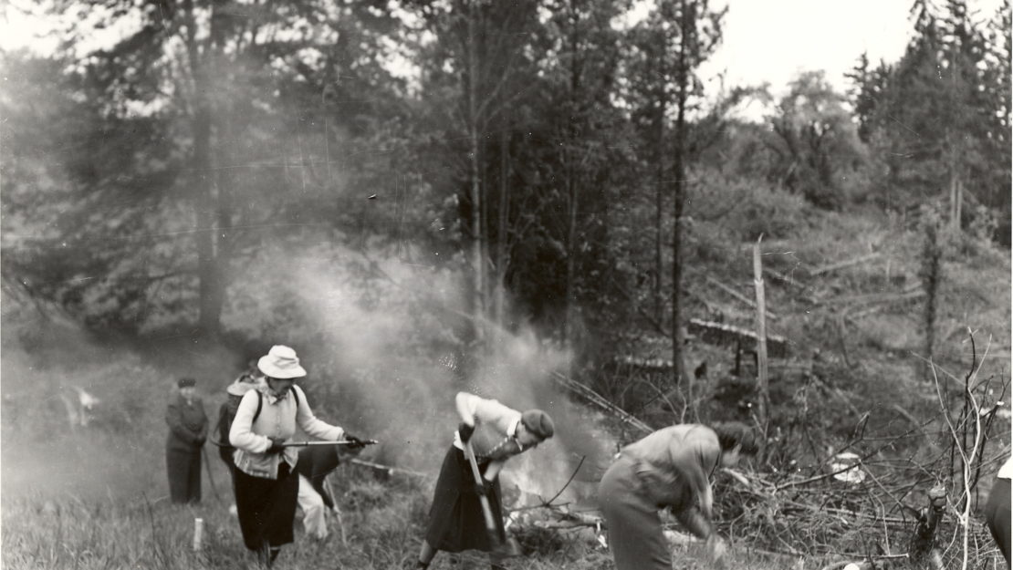 old black and white photo of women fighting wildfire