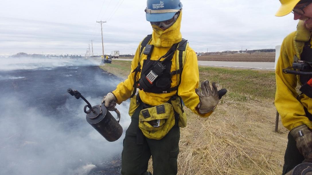 Person in fire gear on a prairie burn