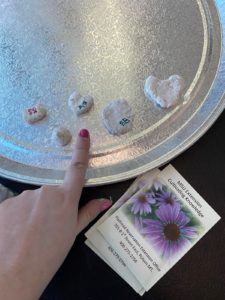 pointing to pebbles on a plate