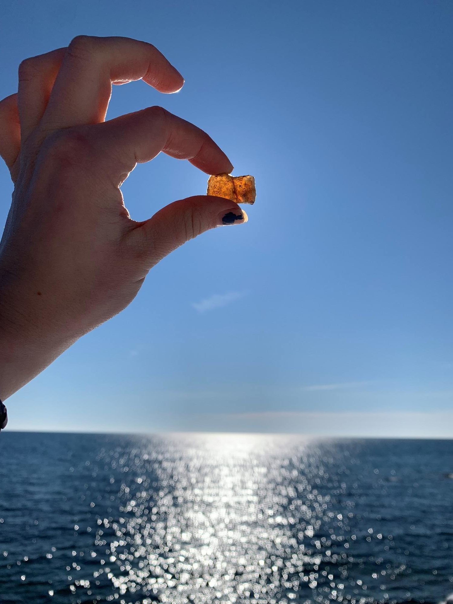 Holding up agate over the lake.