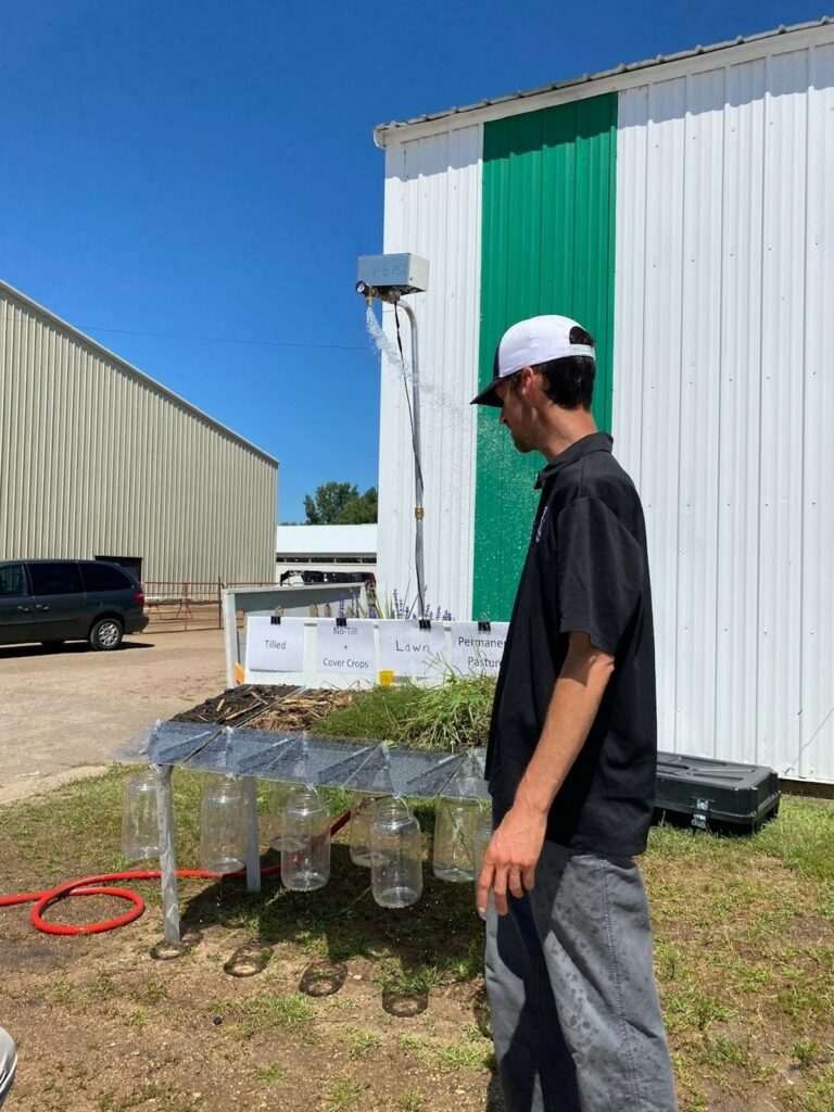 A person looking at a table of equipment with bottles.