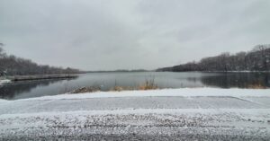 Water in lake with snow in foreground