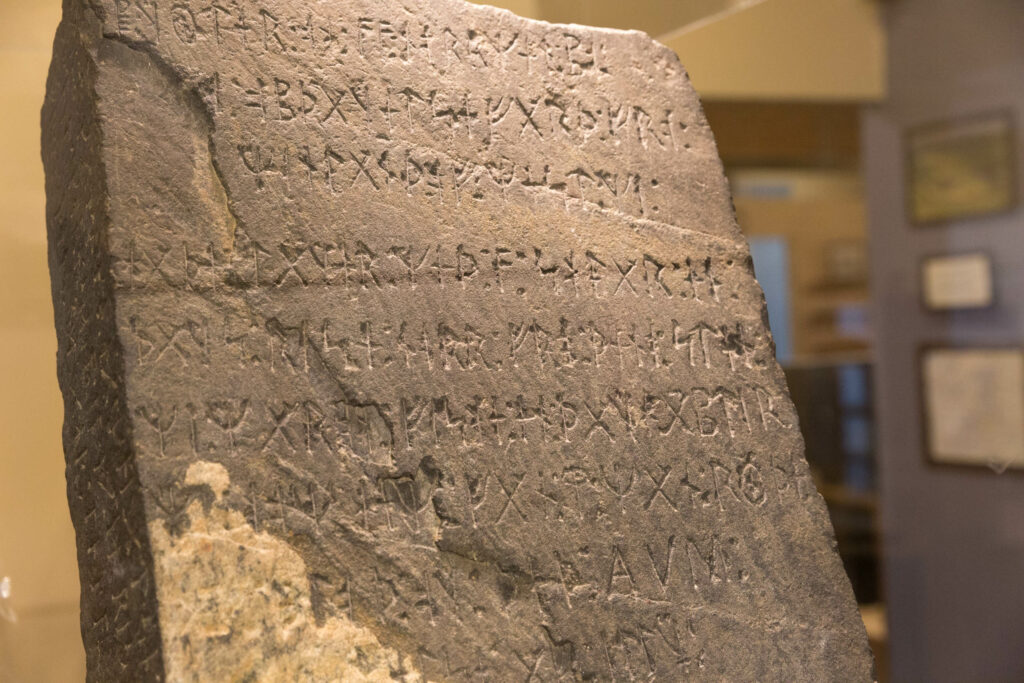 a stone tablet with carved writing on it.