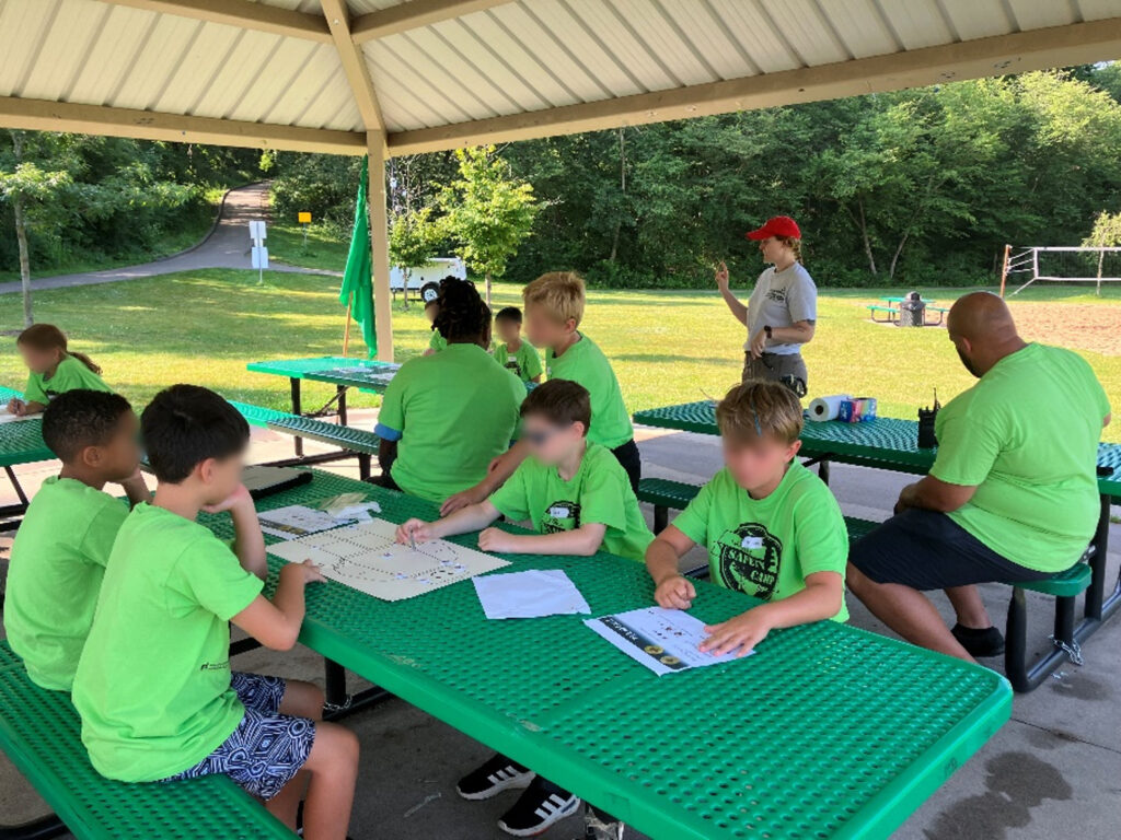 A group of children listening to a person present.