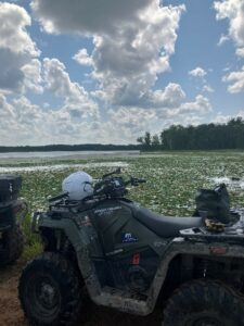 ATV on trail near water.