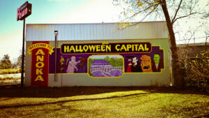 Side of store with a mural that says "Anoka, Halloween Capital."