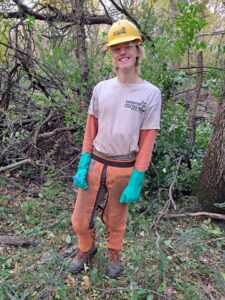 A person in Corps gear in a forest.