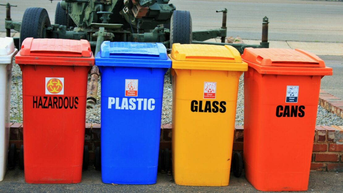 Four plastic recycling containers.