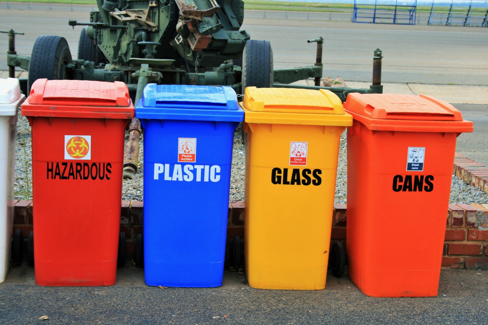 Four plastic recycling containers.