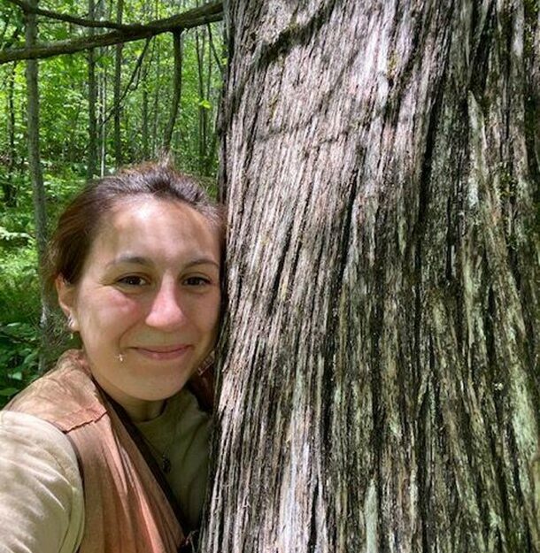 A person next to a tree.