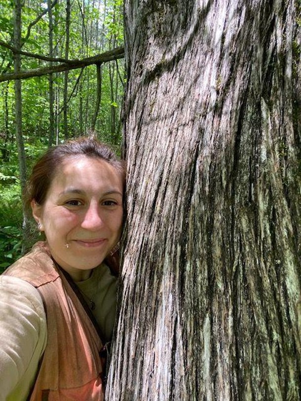 A person next to a tree.