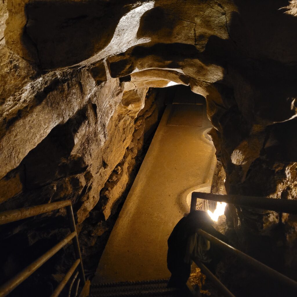 A cave pathway with lights