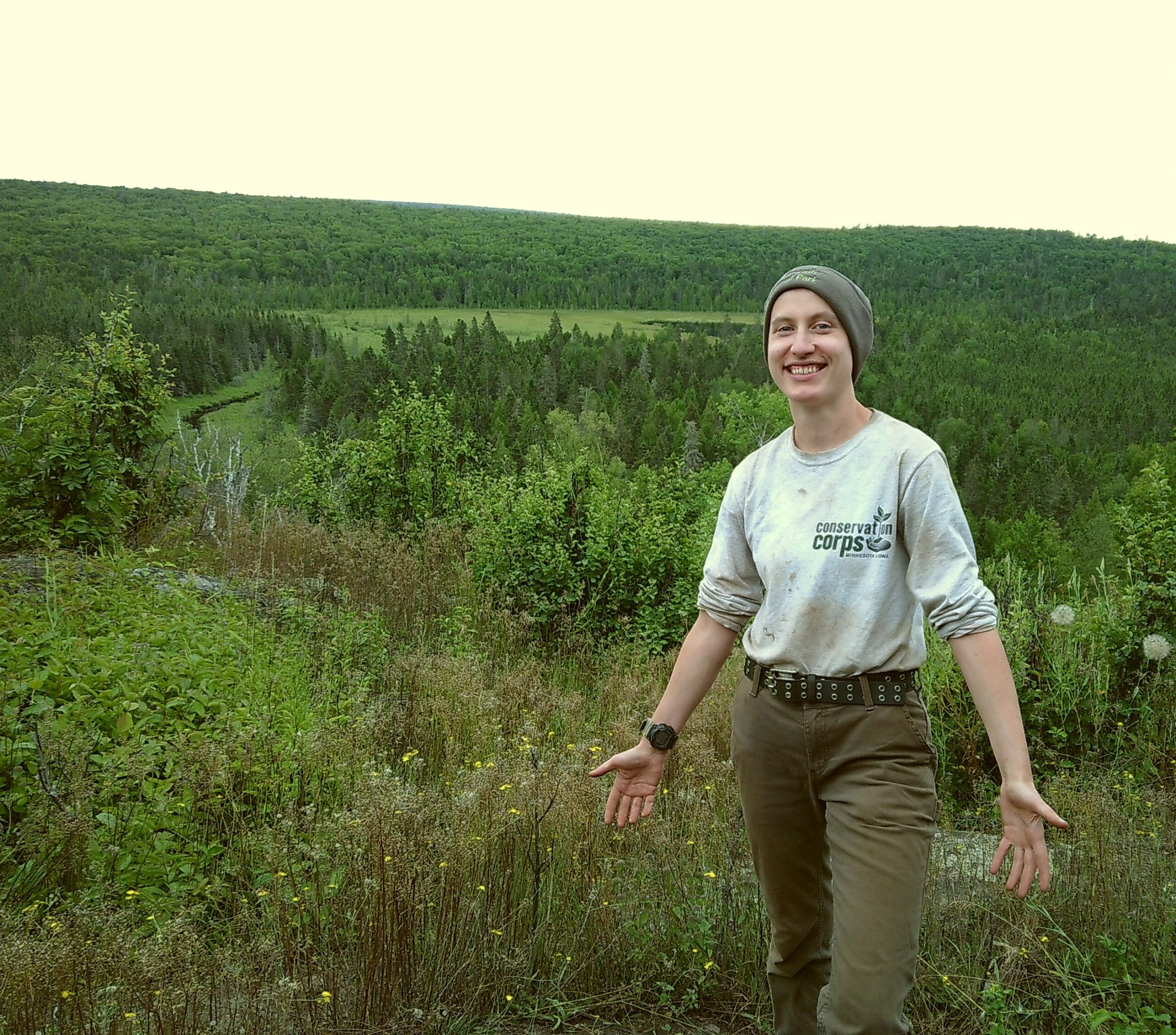A person in Corps gear standing in a natural area.