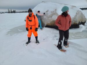 People snowshoeing on a frozen lake