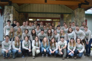 A large group of people posed for a photo wearing CCMI shirts