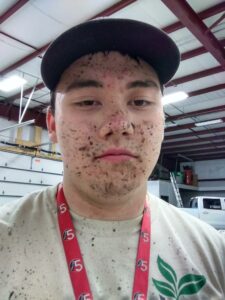 A person's face speckled with mud