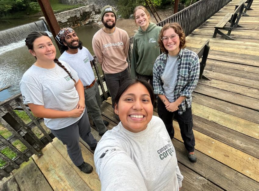 A group of smiling Corpsmembers gathered for a selfie/crew photo.