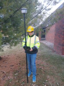 Corpsmember in PPE doing a tree inventory